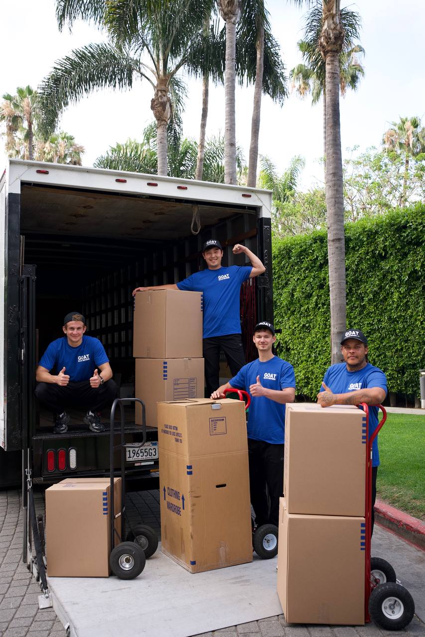 GOAT crew loading the truck with stacked boxes and dollies