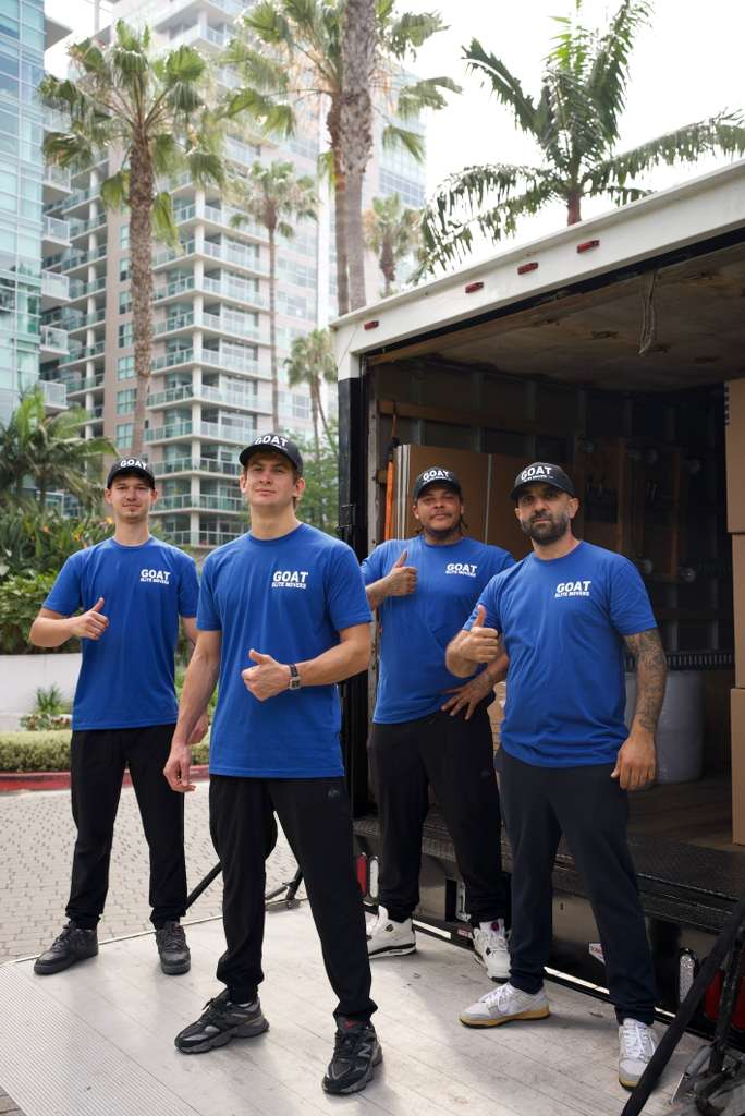 GOAT crew in front of the truck, thumbs up
