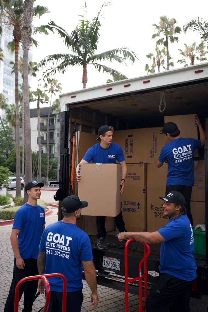 Crew handing boxes inside the truck