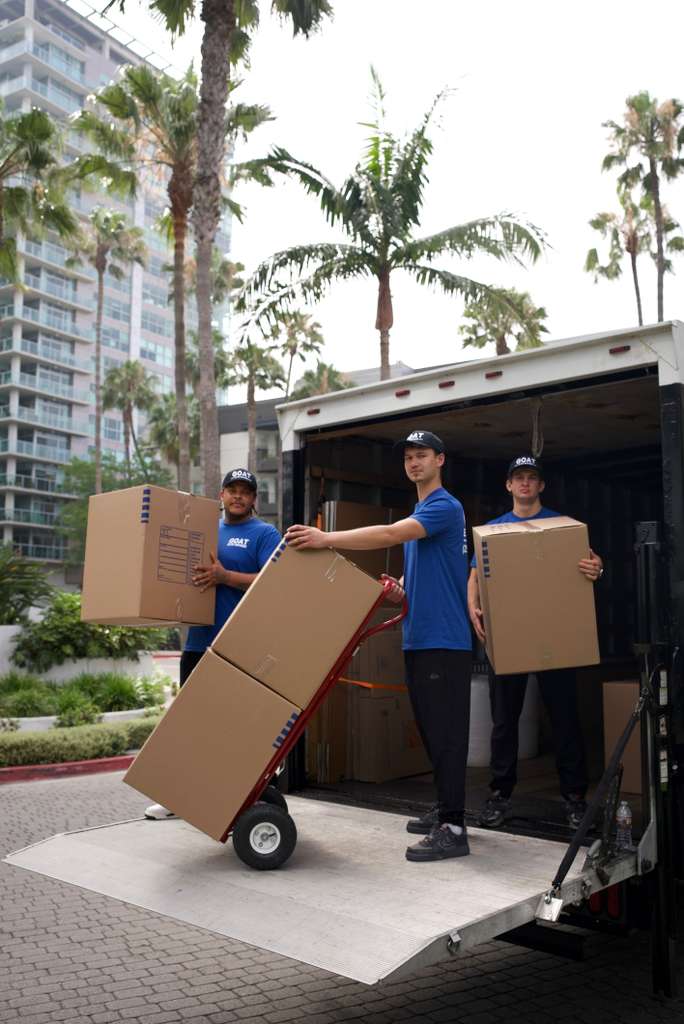 Crew unloading boxes from the truck on a SoCal street