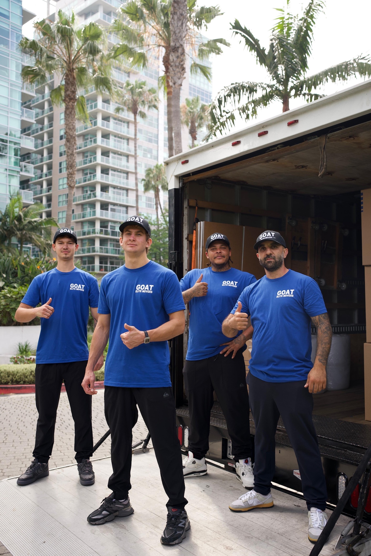 GOAT Elite Movers crew posing in front of the truck in Southern California